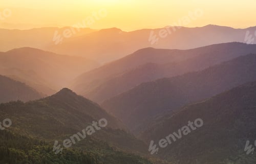 Preview: Mountain slopes during sunset. Landscape in the summertime. Bright sunshine in a mountainous area.