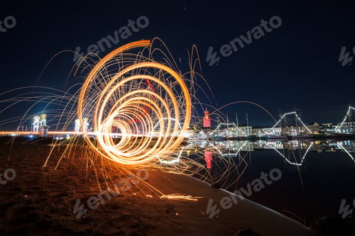 Preview: Fantastic light effect with many sparkles near the water