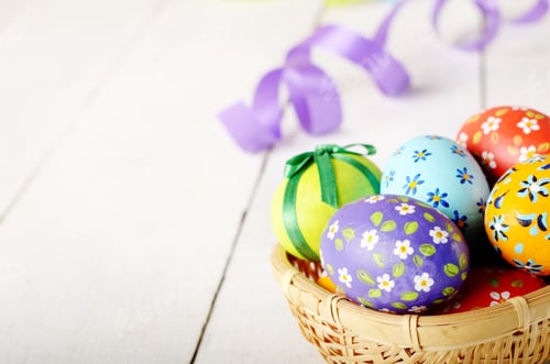 Preview: Rustic style painted easter eggs in basket on white table