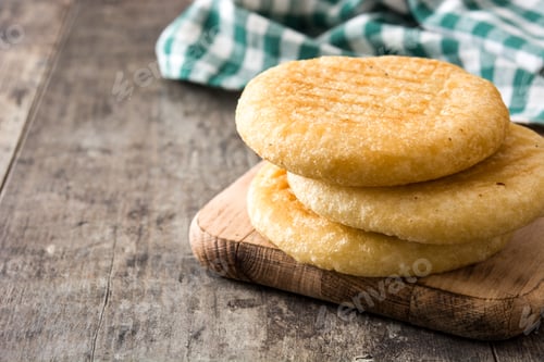 Preview: Delicious arepas resting on wooden board on rustic table