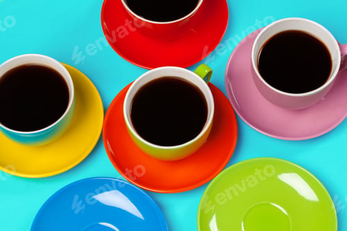 Preview: Colorful coffee cups and saucers on colorful vibrant background