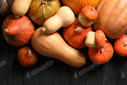 Preview: Flat lay composition with different pumpkins on wooden background. Autumn holidays