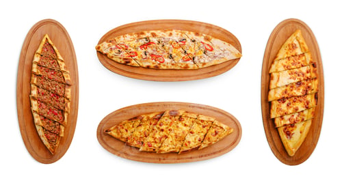 Preview: Variety of Turkish pide served on wooden trays in a casual dining setting