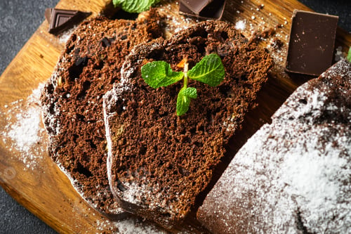 Preview: Chocolate cake with oranges top view on black.