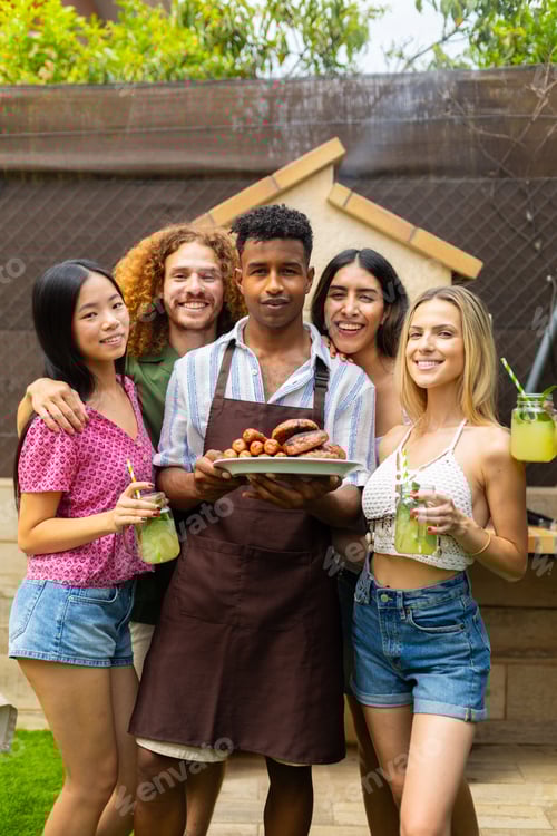Preview: Friends enjoying barbecue food and drinks in backyard