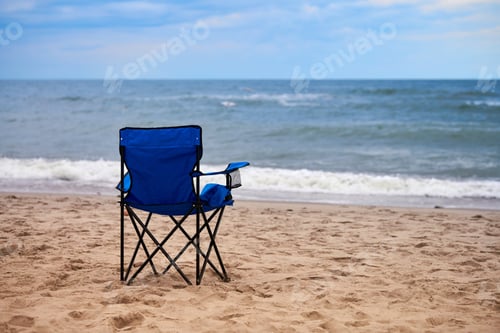 Preview: Blue folding chair back on sea beach, without people, beach holiday alone, loneliness