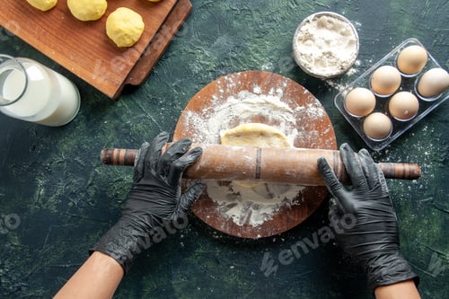 Preview: top view female cook rolling out dough with flour on dark background cake job oven hotcake bake