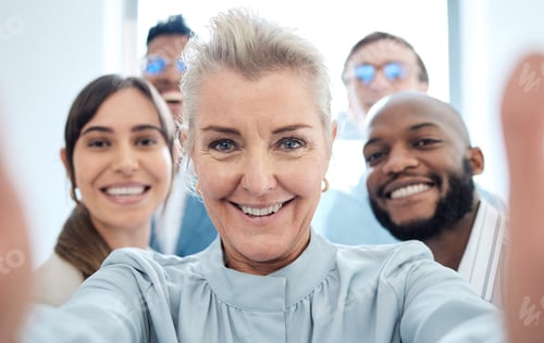 Preview: Portrait of a group of confident businesspeople taking selfies together in an office