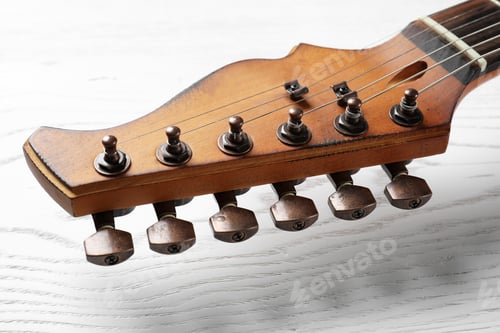 Preview: Modern electric guitar on wooden background, closeup view. Musical instrument