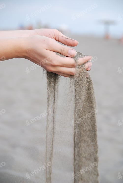 Preview: fine sand leaking trought woman hands