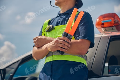 Preview: Man holding marshalling wands in one hand