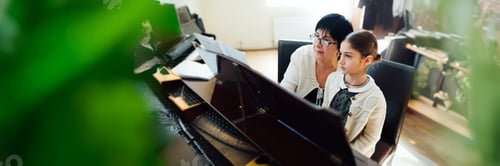 Preview: Piano Lesson with Teacher and Student in Wide Banner