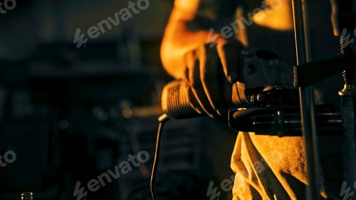 Preview: Close-up of factory worker polishing iron part. Stock footage. Worker with dirty hands polishes iron
