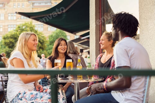 Preview: Friends having beer in sidewalk cafe