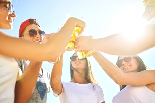 Preview: Group of friends hanging out with beer at the beach. Excellent sunny weather. Beautiful figures.