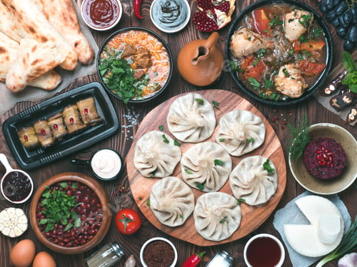 Preview: Georgian cuisine on wooden table, top view