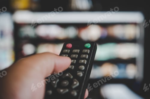 Preview: Watching television, with a tv remote control in the hand