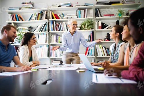 Preview: Successful group of business people at work in office
