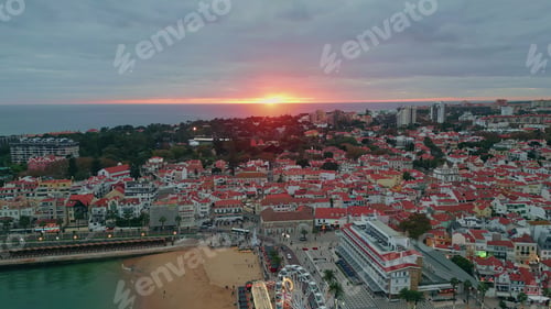 Preview: Sunrise illuminate coastal cityscape aerial view. Morning descending on sea