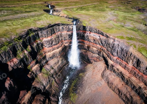 Preview: Hengifoss waterfall surrounded by layers of basaltic strata with water flowing in summer at Iceland