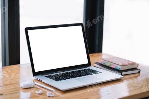Preview: Laptop computer with blank white screen on table.
