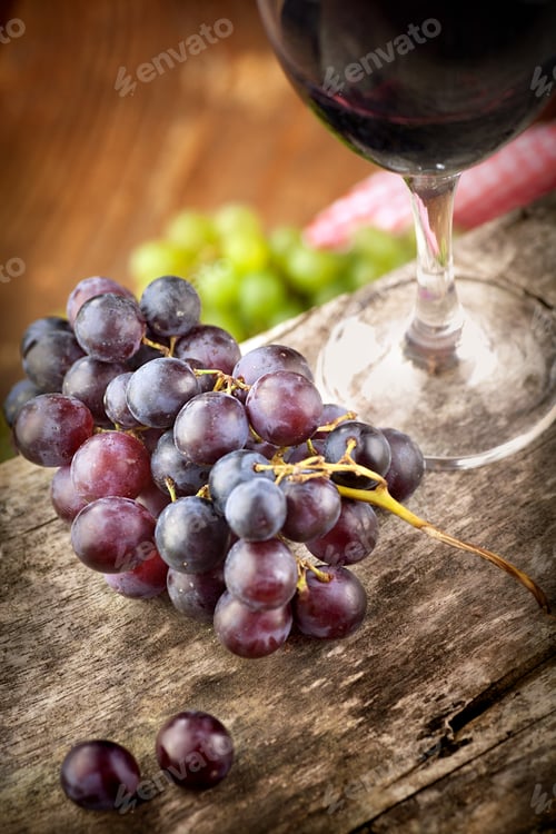 Wine and Grapes on Rustic Wooden Background