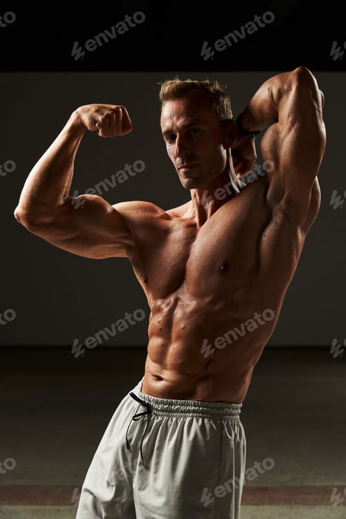 Preview: A symphony of sinew as a young, muscular man flexes, each muscle dancing in harmonious display, a