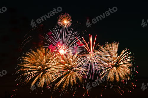 Preview: Bright colored fireworks on a festive night. Explosions of colored fire in the sky.