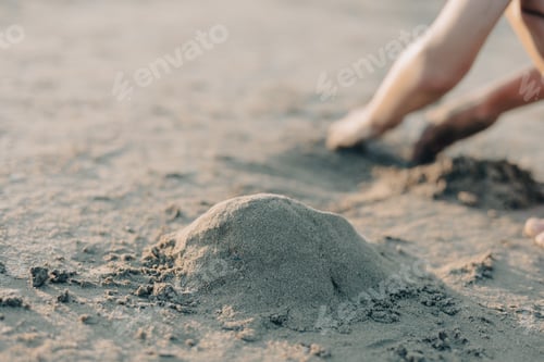 Preview: Selective focus childrens hands playing with sand on summer beach. Vacation concept.