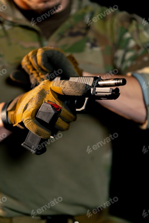 Preview: close-up at a professional shooting range a military trainer reloading a pistol ready to shoot