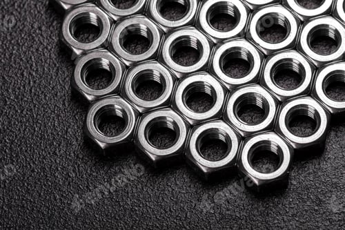 Preview: Metal steel nuts laid in composition on a dark table