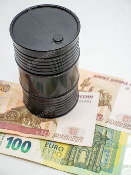 Preview: Small plastic oil barrel on paper money on white table - black gold concept