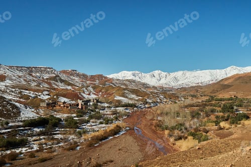 Preview: Ancient city near river between hills in snow and wonderful sky
