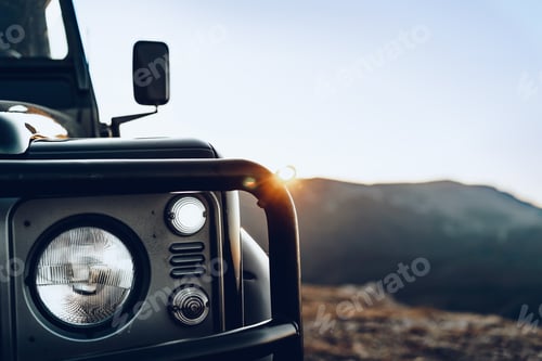 Preview: Dark green off-road car in the mountains