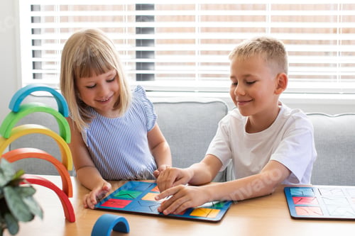 Preview: Brother and sister are playing educational wooden logic games. The concept of child development