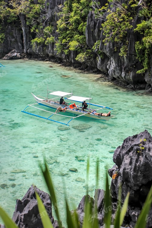 Preview: Tourists enjoying a serene boat ride in a crystalclear lagoon