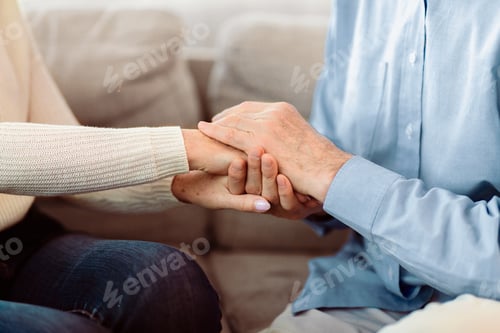 Preview: Affectionate Couple Holding Hands in a Bright Home