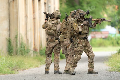 Preview: Special forces soldier in camouflage with a pair of weapons that are full of modern technology