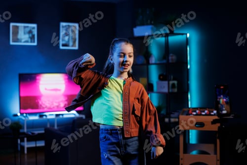 Preview: Gen Z entertainer does viral dance choreography in neon lit apartment, filming with cellphone
