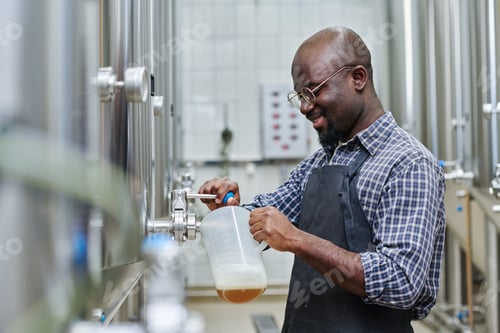 Preview: Factory worker tasting brewed beer