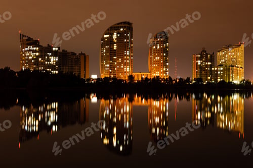 Preview: night city with reflection of houses in the river