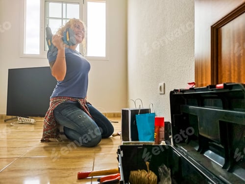 Preview: Happy and tired woman rest on the floor after home works