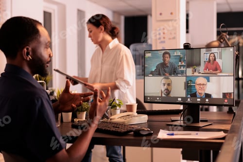 Preview: African american man speaking to remote team on videocall