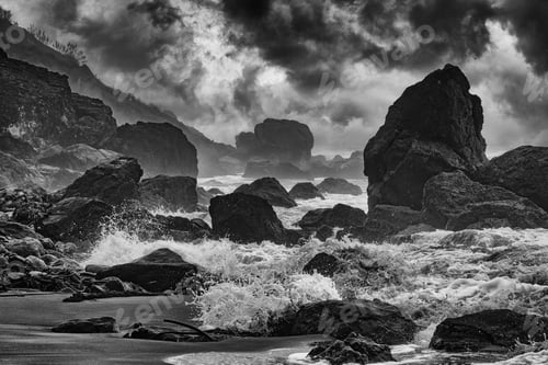 Preview: Black and white of the waves of Muir Beach in California crashing against the rocky shoreline