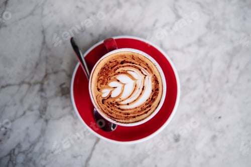 Preview: Latte art, rosetta flower on a cappuccino at a cafe.