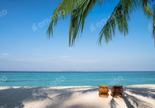 Preview: Wooden sunbed with palm leaves on the beach