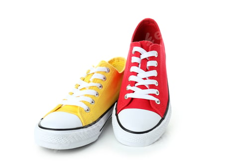 Preview: Pair of red and yellow sneakers isolated on white background