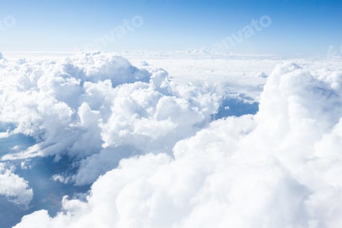 Preview: Fluffy white clouds stretch across a bright blue sky during a sunny day in a serene atmosphere above