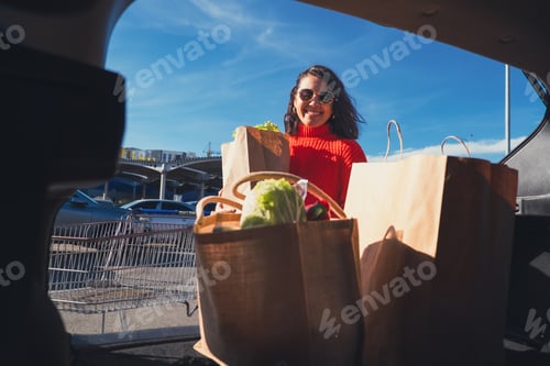 Preview: woman put packages in car trunk