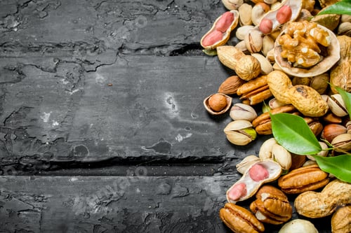 Preview: Nuts background. Different kinds of nuts with leaves.